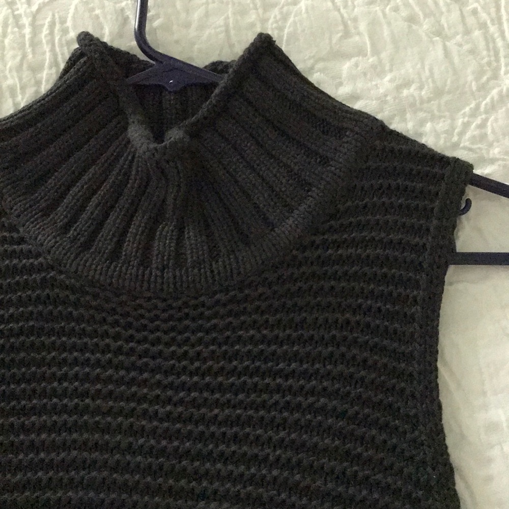 Tunic length sleeveless sweater.